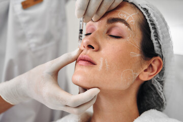 A woman gets injections in the face.