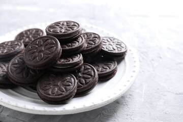 Many tasty sandwich cookies on light grey table