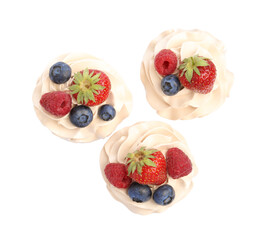 Tasty cupcakes with different berries isolated on white, top view