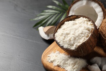 Organic coconut flour and fresh fruits on black table, closeup. Space for text