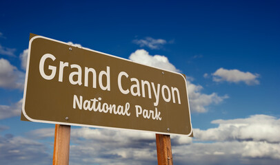Grand Canyon National Park (Arizona) Road Sign Against Blue Sky and Clouds.