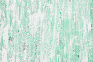 Light green mint wooden background in a cool tone. Wood texture with vertical stripes and knots for wallpaper, graphic design, creativity. Top view, horizontal orientation