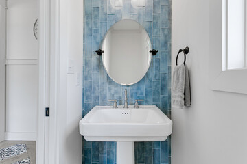 Modern Bathroom Sink With Round Mirror And Blue Subway Tile Backsplash