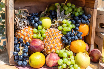 Wooden Basket with different kind of healthy summer fruits. 