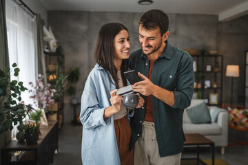 Portrait of couple buy online on mobile phone with credit card at home