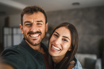 Self portrait of happy couple hug and have fun at home