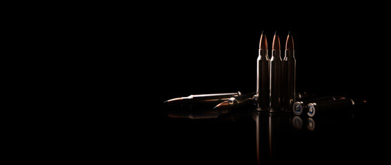 Bullet isolated on black background with reflexion. Rifle bullets close-up on black back....