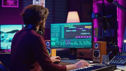 Audio engineer working at home music studio with daw software and equalizer mixing gear on screen....