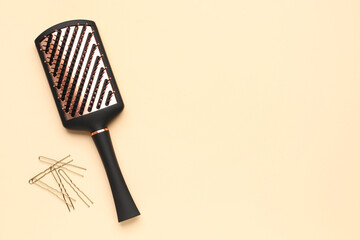 Hairpins with brush on beige background