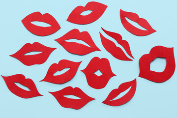 Red paper lips on blue background