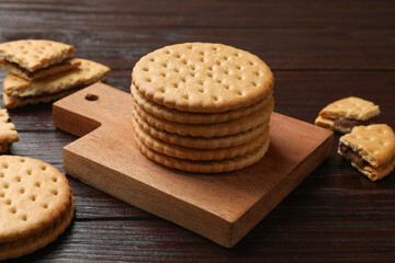 Tasty sandwich cookies on wooden table, closeup