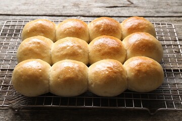 Many delicious dough balls on wooden table