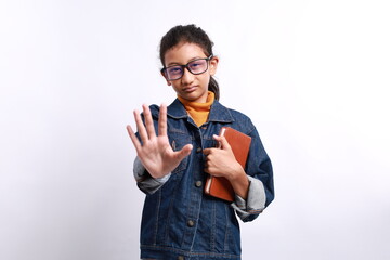 Young little asian student kid wearing smart glasses and holding a book from school with open hand...