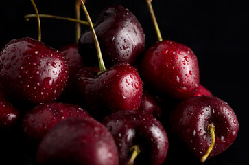 Macro of Delicious Fresh Red Wet Cherries with Black Background