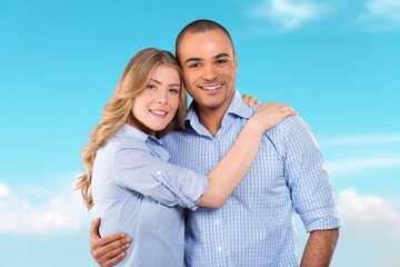 Obraz premium Young happy couple standing and hugging