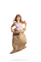 Happy girl jumping in a sack