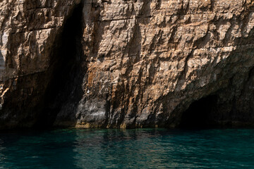 Rocky landscape and blue water in Zakynthos Island, landmark attraction in Greece. Ionian Sea.