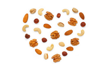 Background from various nuts and seeds with copy space for text in the form of a heart. Isolated on white background. Flat lay, top view