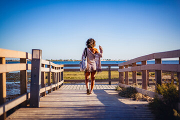 woman walking on the bridge in ria formosa nature park in algarve