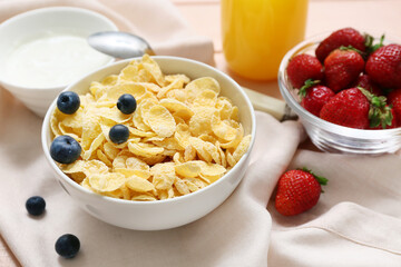 Bowl with cornflakes and berries on napkin as background, closeup