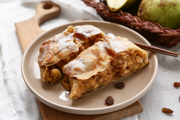 Plate with pieces of tasty pear strudel, closeup
