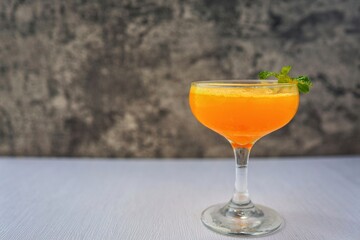Fresh orange juice in a glass on a white table 