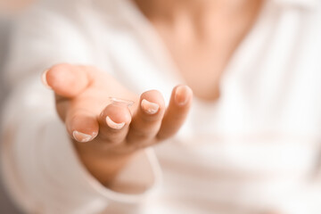 Young woman with contact lens at home, closeup
