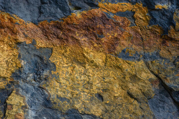 Macro photography of a black and golden rock texture, captured in a mountain of the eastern Andean range o central Colombia.