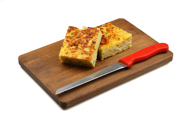 Slices of baked Round Borek cheese pie in kitchen tray with herbs. White background. Top view. Copy space