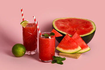 Glasses of fresh watermelon juice with lime and mint on pink background