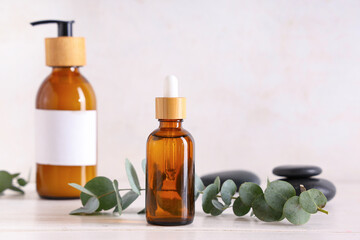 Bottles of eucalyptus essential oil on white background, closeup