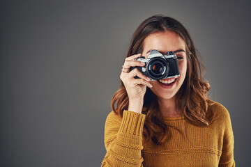 Woman, portrait and photographer with camera for picture, memory and professional in studio mockup. Student, happy and photography equipment for creativity, portfolio and space by gray background