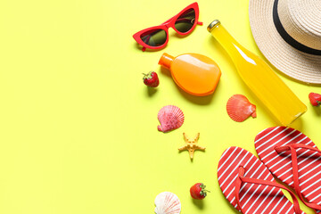 Stylish striped flip-flops with bottle of cocktail, sunglasses, seashells, strawberries and sunscreen cream on yellow background