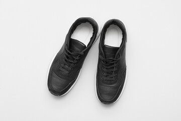 Stylish male black sneakers on grey background