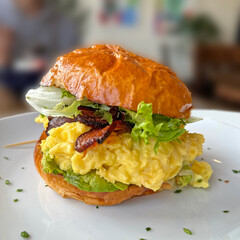 Breakfast Sandwich with scrambled eggs, bacon, lettuce and Golden Buttery Bun