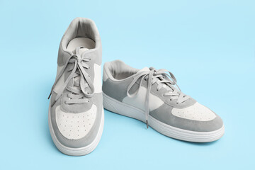 Stylish male sneakers on blue background