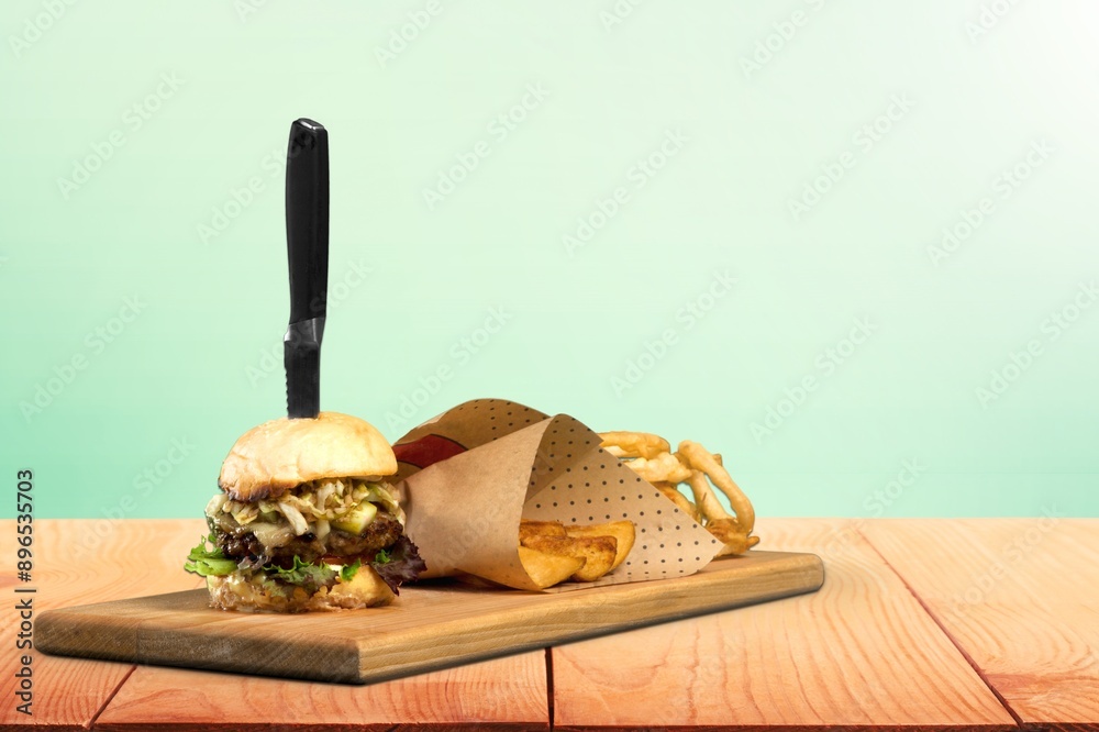 Poster classic tasty hot cheeseburger on wood desk