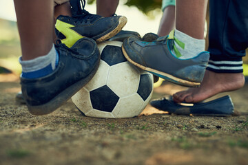 People, legs and soccer ball in sports ground for football match, game and tournament. Outdoor, team mates and training with practice, preparation and fitness for competition on with teamwork