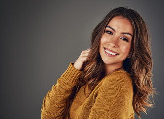 Obraz premium Hair care, smile and portrait of woman in studio with volume, salon and routine for shine. Beauty, confident and person with collagen treatment for scalp hydration for hairstyle by gray background.