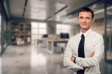 Happy confident business man standing in office