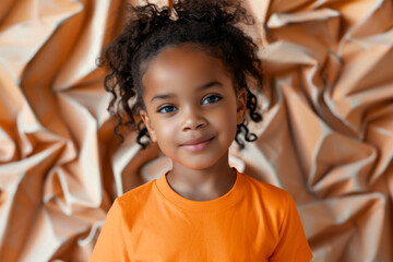 Portrait of a girl wearing an orange shirt. Orange t-shirt day concept