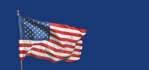 Fototapeta premium The American flag on blue sky background