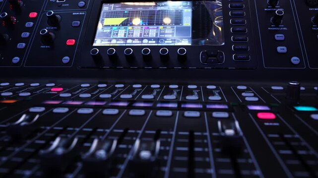 Black audio mixer with screen and buttons. Focus selected