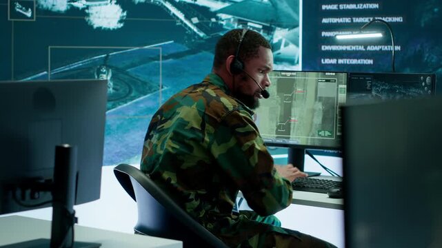 Soldiers in a modern command center analyze live data from cctv radar sources, satellite feeds and surveillance systems. Intelligence to support strategic planning and military operations. Camera A.