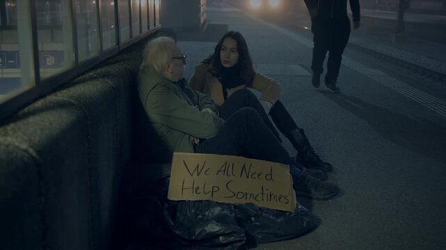 Homeless group on city sidewalk at night, showing challenges and need for compassion in urban areas
