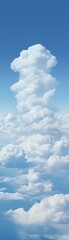 Obraz premium Vertical view of a beautiful cumulus cloud formation against a clear blue sky, capturing the serene and majestic nature of the atmosphere.