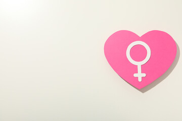 Pink silhouette of a woman's heart on a white background.