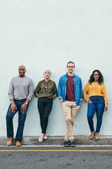 Obraz premium Creative, team and portrait of business people by wall for partnership, confidence and collaboration. Employee pride, diversity and smile for company, development and opportunity with mockup space