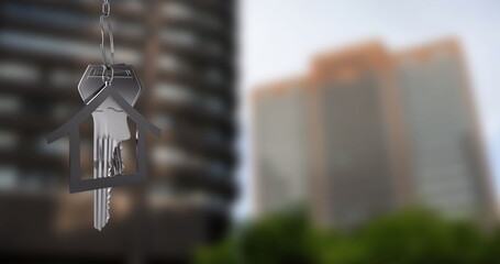 Image of silver keys and house over cityscape
