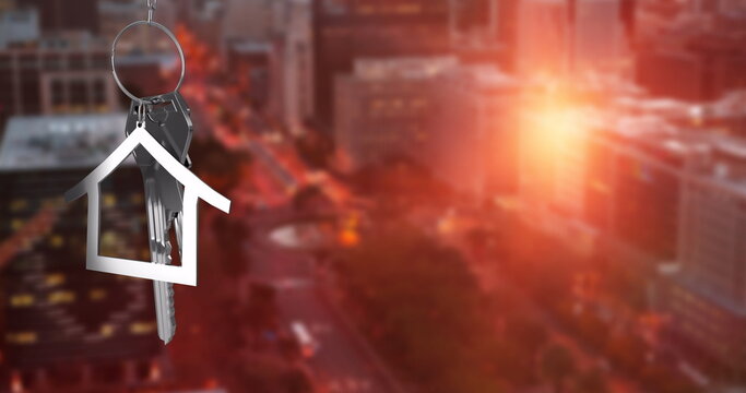 Image of silver house key over cityscape - Powered by Adobe